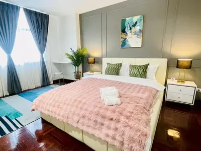 a bedroom with a large bed with a pink blanket at Private Pool Villas Sukhumvit 26 Near BTS Phrom Phong and EmSphere in Bangkok