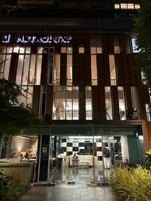 a building with a sign on the front of it at Welcome to warm room here have gym saona Netflix in Bangkok