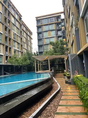 a swimming pool in the middle of two buildings at Welcome to warm room here have gym saona Netflix in Bangkok
