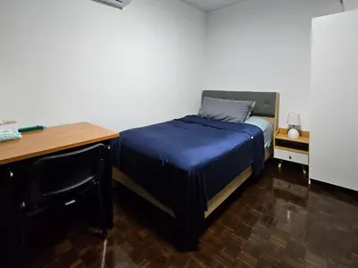 a bed in a room with a desk and a bed sidx sidx sidx at Kuma House Sukhumvit in Bangkok