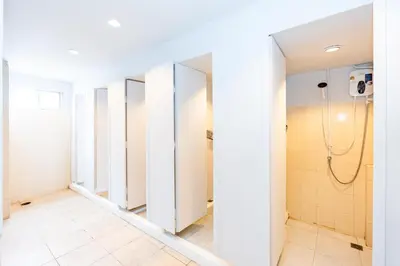 a walk in shower in a bathroom with mirrors at xx เดอะ ฮิดเด้น ตรอก ข้าวสาร The Hidden Khaosan in Bangkok