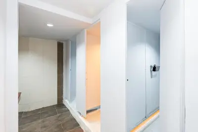 a bathroom with white walls and a walk in shower at xx เดอะ ฮิดเด้น ตรอก ข้าวสาร The Hidden Khaosan in Bangkok