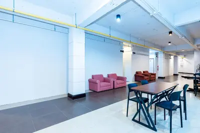 a room with a table and chairs and a couch at xx เดอะ ฮิดเด้น ตรอก ข้าวสาร The Hidden Khaosan in Bangkok