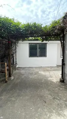 a white garage with a window on it at Baan Yard - More than 5 nights stay in Bangkok