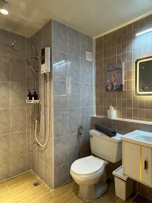 a bathroom with a toilet and a shower at MoonStay C5 Impactarena-Donmuang-FreeSpeedWifi in Thung Si Kan