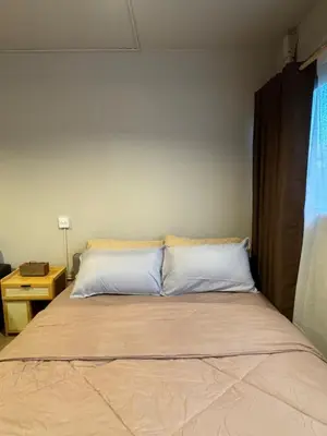 a bed with white pillows in a bedroom at MoonStay C5 Impactarena-Donmuang-FreeSpeedWifi in Thung Si Kan