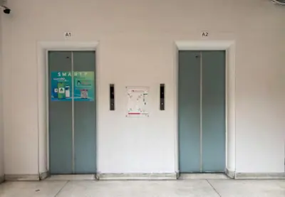three elevators in a building with blue doors at MoonStay C1 Impact Arena Muangthongthani-Donmuang-FreeSpeedWifi in Nonthaburi