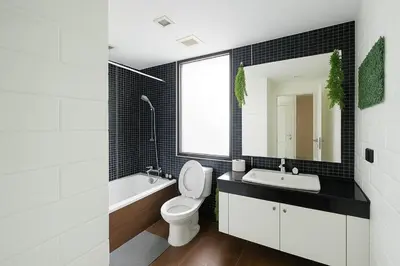 a bathroom with a toilet and a sink and a mirror at Modern 2 Bed Executive Unit - 5min to Nana BTS in Bangkok