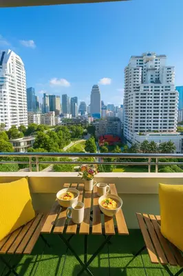 a table on a balcony with a view of a city at Modern 2 Bed Executive Unit - 5min to Nana BTS in Bangkok