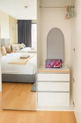 a bedroom with two beds and a mirror at Modern 2 Bed Executive Unit - 5min to Nana BTS in Bangkok