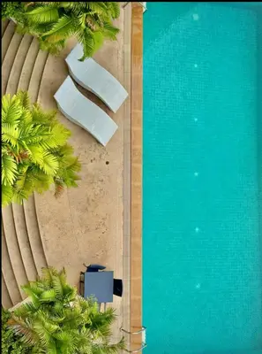 an overhead view of a swimming pool with palm trees at Modern 2 Bed Executive Unit - 5min to Nana BTS in Bangkok