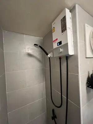 a shower with a hose in a bathroom with a shower at Lazy House at Impact Muangthong in Thung Si Kan