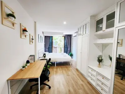 a bedroom with a bed and a desk in a room at Cozy Private Family Apartment in Bangkok CBD Silom-Sathorn - 240m to BTS Saint Louis in Yan Nawa