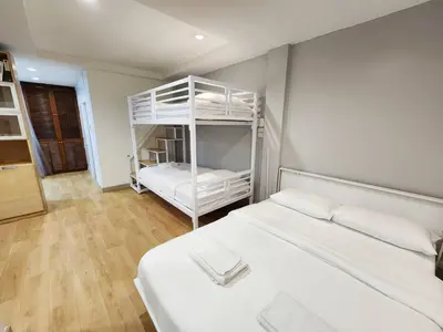 a bedroom with two bunk beds in a room at Cozy Private Family Apartment in Bangkok CBD Silom-Sathorn - 240m to BTS Saint Louis in Yan Nawa