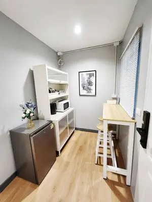 a kitchen with a desk and a refrigerator and a table at Cozy Private Family Apartment in Bangkok CBD Silom-Sathorn - 240m to BTS Saint Louis in Yan Nawa