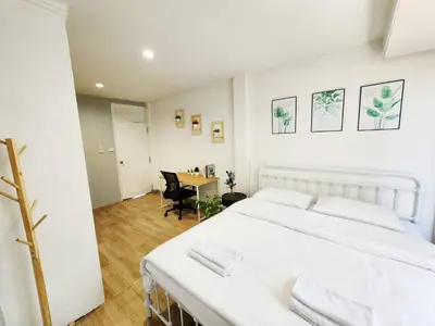 a white bedroom with a bed and a desk at Cozy Private Family Apartment in Bangkok CBD Silom-Sathorn - 240m to BTS Saint Louis in Yan Nawa