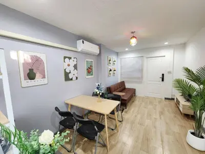 a living room with a table and chairs and a couch at Cozy Private Family Apartment in Bangkok CBD Silom-Sathorn - 240m to BTS Saint Louis in Yan Nawa