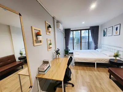 a bedroom with a bed and a desk and a table at Cozy Private Family Apartment in Bangkok CBD Silom-Sathorn - 240m to BTS Saint Louis in Yan Nawa