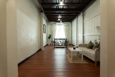 a living room with a couch and a table at House of Patcha เรือลพัชชา Hostel share bathroom in Bangkok