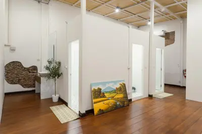 a large painting on the floor of a room with white walls at House of Patcha เรือลพัชชา Hostel share bathroom in Bangkok