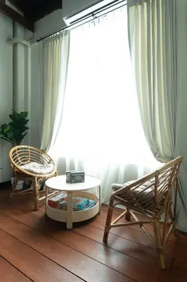 a room with two chairs and a table and a window at House of Patcha เรือลพัชชา Hostel share bathroom in Bangkok