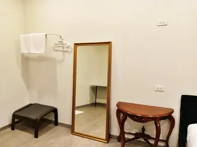 a mirror and a table and a stool in a room at HD China Town MRT Dragon Temple กลางเยาวราช in Bangkok