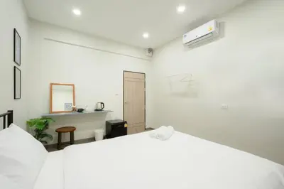 a white bedroom with a white bed and a desk at HD China Town MRT Dragon Temple กลางเยาวราช in Bangkok