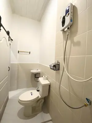 a white bathroom with a toilet and a shower at xx Rest Inn Yaowarat เรสอินน์ เยาวราช in Samphanthawong