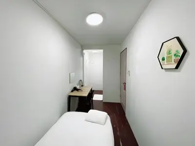 a small room with a bed and a desk at xx GO INN Siriraj BKK - โกอินน์ โรงพยาบาล ศิริราช in Bangkok Noi