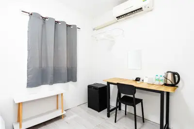 a room with a desk and a table with a chair at xx GO INN Siriraj BKK - โกอินน์ โรงพยาบาล ศิริราช in Bangkok Noi