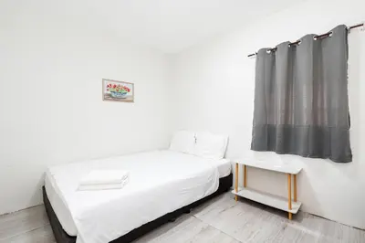 a small bedroom with a bed and a curtain at xx GO INN Siriraj BKK - โกอินน์ โรงพยาบาล ศิริราช in Bangkok Noi