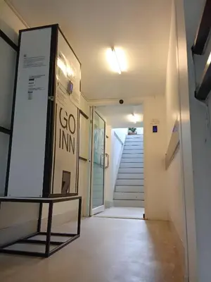 a hallway with a sign in front of a door at XX Wish Inn Chidlom - วิช อินน์ ชิดลม in Bangkok