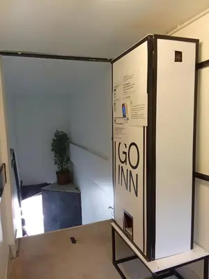 a large box in a room with a plant at XX Wish Inn Chidlom - วิช อินน์ ชิดลม in Bangkok