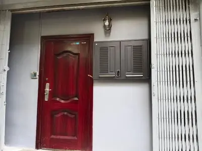 a red door on the side of a building at Capricorn hostel Yaowarat in Chinatown