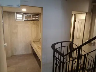 a room with a staircase leading to a room with a door at XX GO INN Silom BTS Surasak สถานีสุรศักดิ์ in Yan Nawa