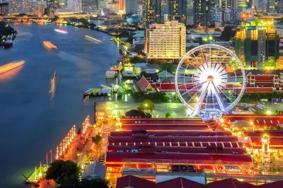 a city skyline at night with a ferris wheel at XX GO INN Asiatique Bangkok โก อินน์ เอเชียทีค เจริญกรุง in Bangkok