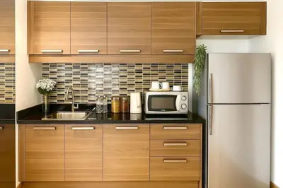 a kitchen with a refrigerator and a microwave at Executive Suite 2 Beds Nana BTS 5 mins in Bangkok