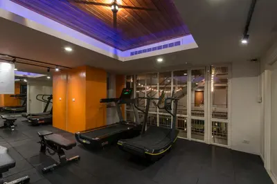 a gym with several exercise equipment in a room at Nanda Heritage Hotel in Bangkok