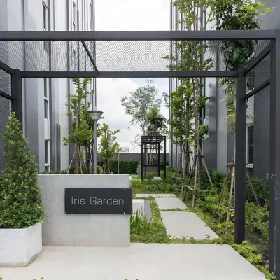 a sign for its garden in front of a building at Laid back at IRIS Westgate Bangkok-Nonthaburi in Ban Bang Phai