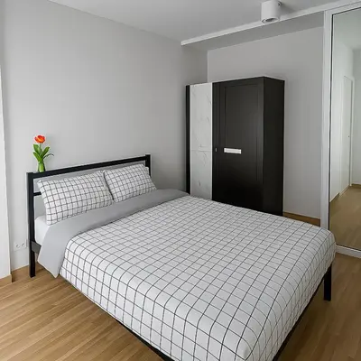 a bedroom with a bed and a black cabinet at Laid back at IRIS Westgate Bangkok-Nonthaburi in Ban Bang Phai