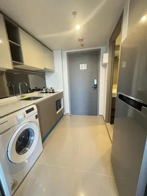 a kitchen with a washing machine and a sink at City Lights Retreat in Bangkok