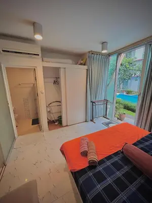 a bedroom with a bed with an orange blanket at Modern Condo with Full Amenities Bangkok in Sathani Ban Hua Mak