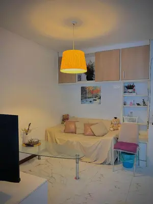a living room with a couch and a table at Modern Condo with Full Amenities Bangkok in Sathani Ban Hua Mak