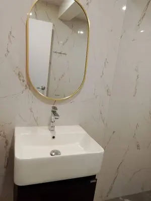 a bathroom with a white sink and a mirror at Lovely Townhome in Shopping District near BTS&MRT in Bang Su