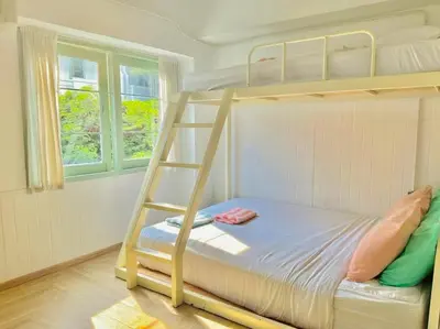 a bunk bed with a ladder in a room at Bangkok Group Bunk Hotel Khaosan in Bangkok