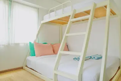 a bunk bed with a ladder in a room at Bangkok Group Bunk Hotel Khaosan in Bangkok