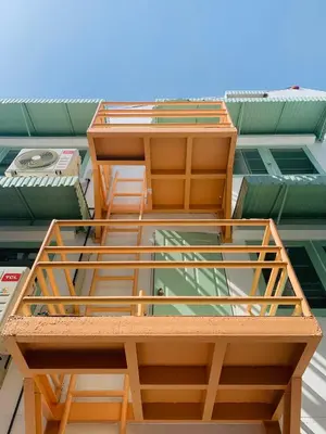 a building with two chairs on top of it at Bangkok Group Bunk Hotel Khaosan in Bangkok
