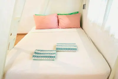 two pillows on a bed in a small room at Bangkok Group Bunk Hotel Khaosan in Bangkok