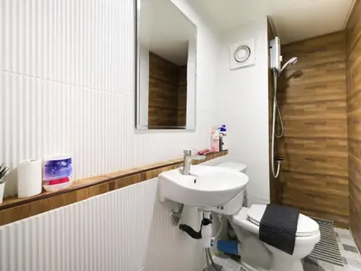 a bathroom with a sink and a toilet at Cozy 2BR Near Impact Arena, LTAT- WiFi Washer near DMK at C2 in Ban Song Hong