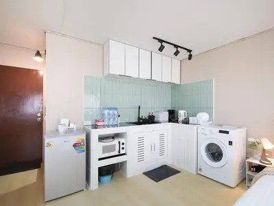 a kitchen with a washing machine and a washer at Cozy 2BR Near Impact Arena, LTAT- WiFi Washer near DMK at C2 in Ban Song Hong